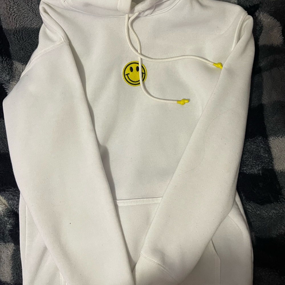 white hoodie with smiley face
